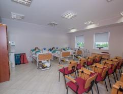 Sala opiekuna medycznego w budynku TEB przy ulicy Polnej w Piotrkowie Trybunalskim, widok na krzesła tapicerowane z pulpitami oraz łóżka medyczne z fantomami